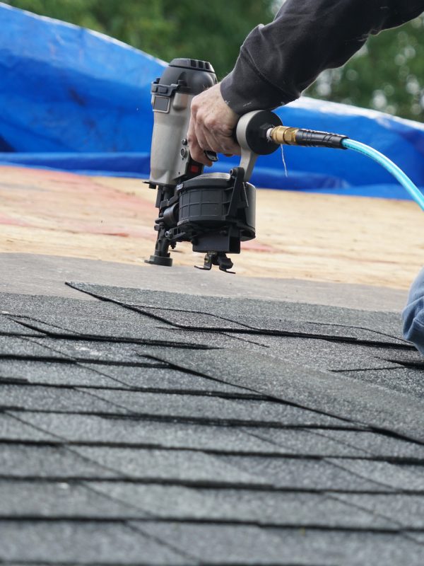 roofer nailing down a new roof