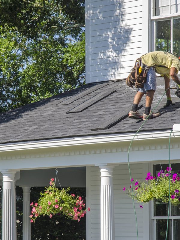 roofing contractor fixing a house